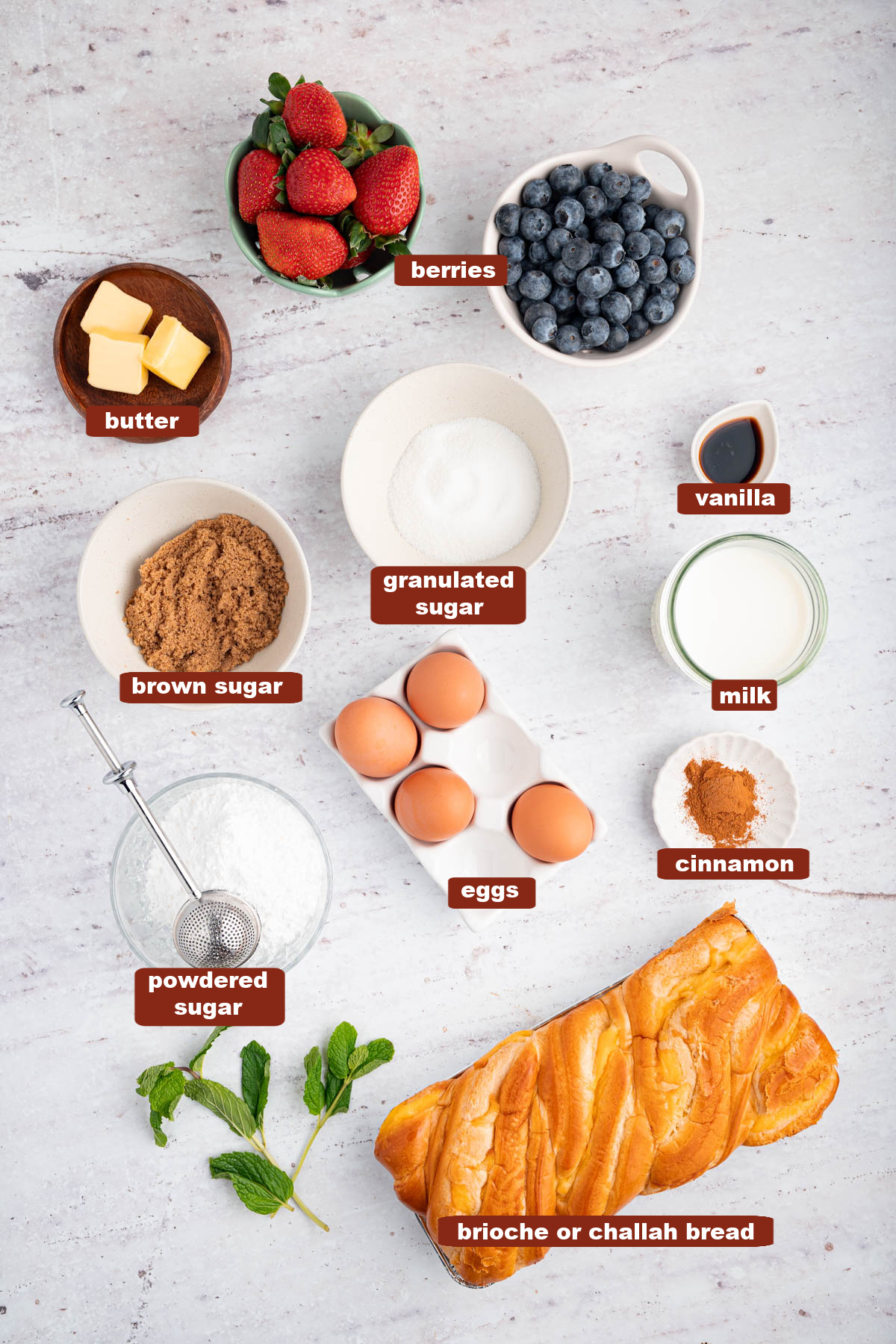 All of the ingredients for the french toast waffles in bowls on a white countertop.