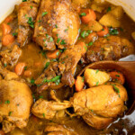 Jamaican Chicken Curry in a pan on the stove after cooking.