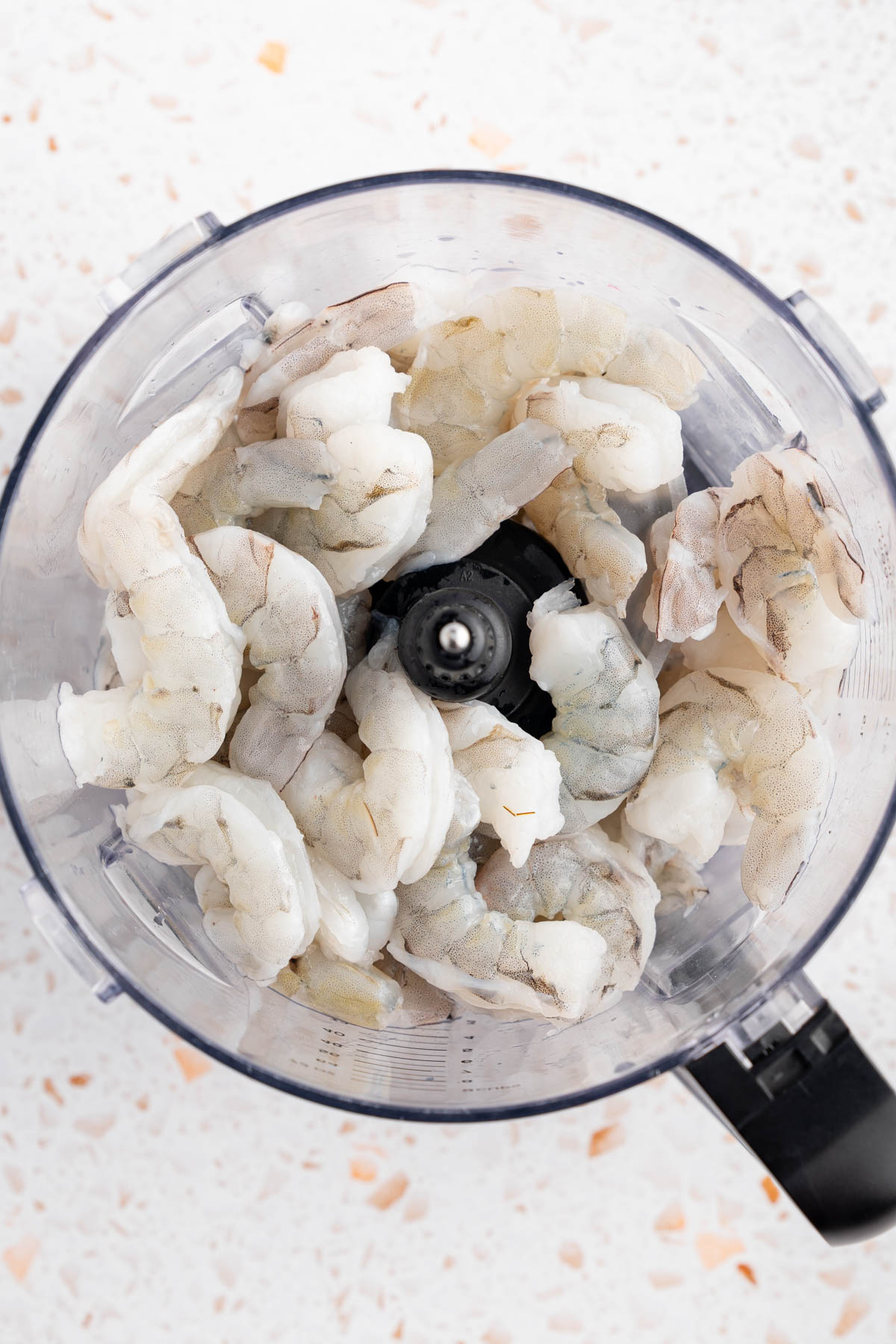 The shrimp in the food processor before processing.