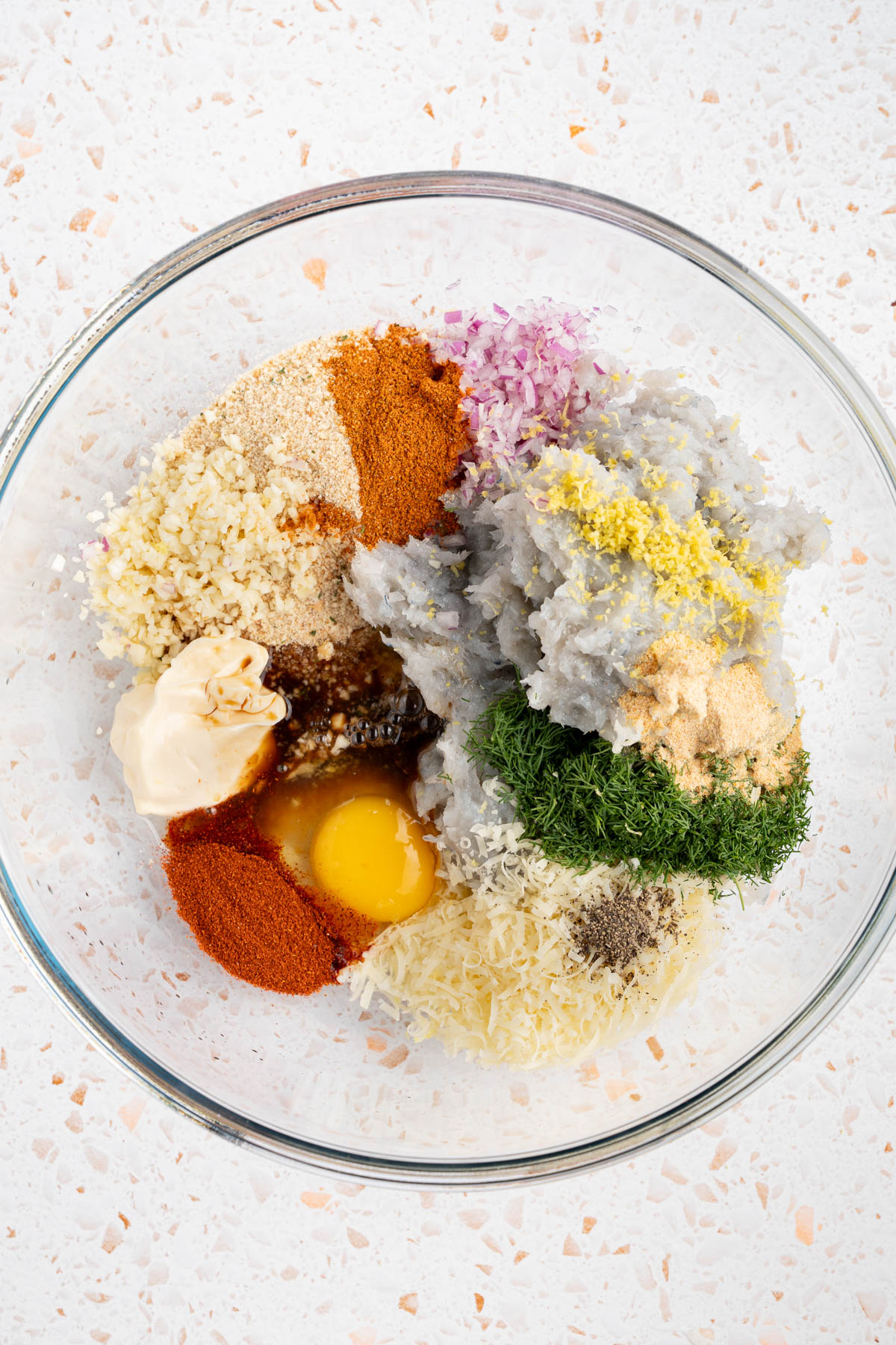 All of the shrimp burger ingredients in a large bowl before mixing together.