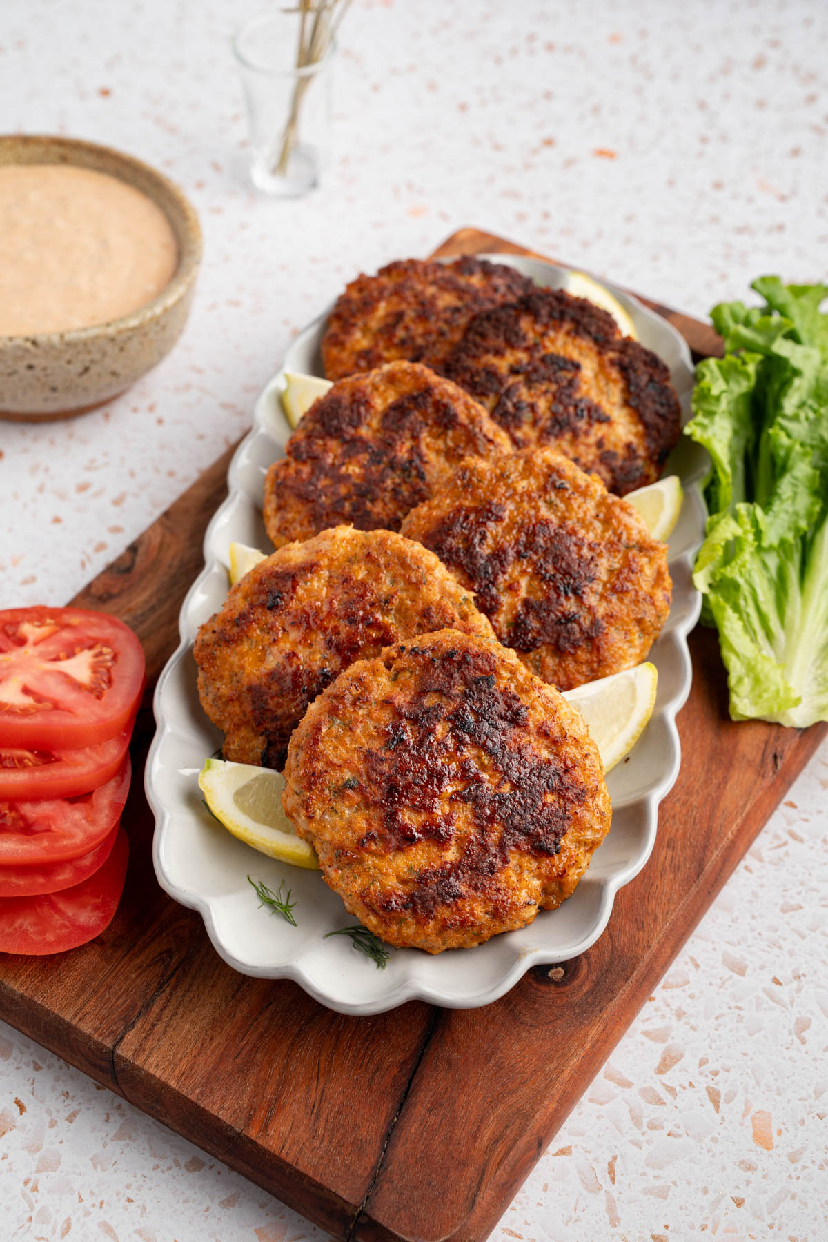 Shrimp burgers on a plate before assembling.