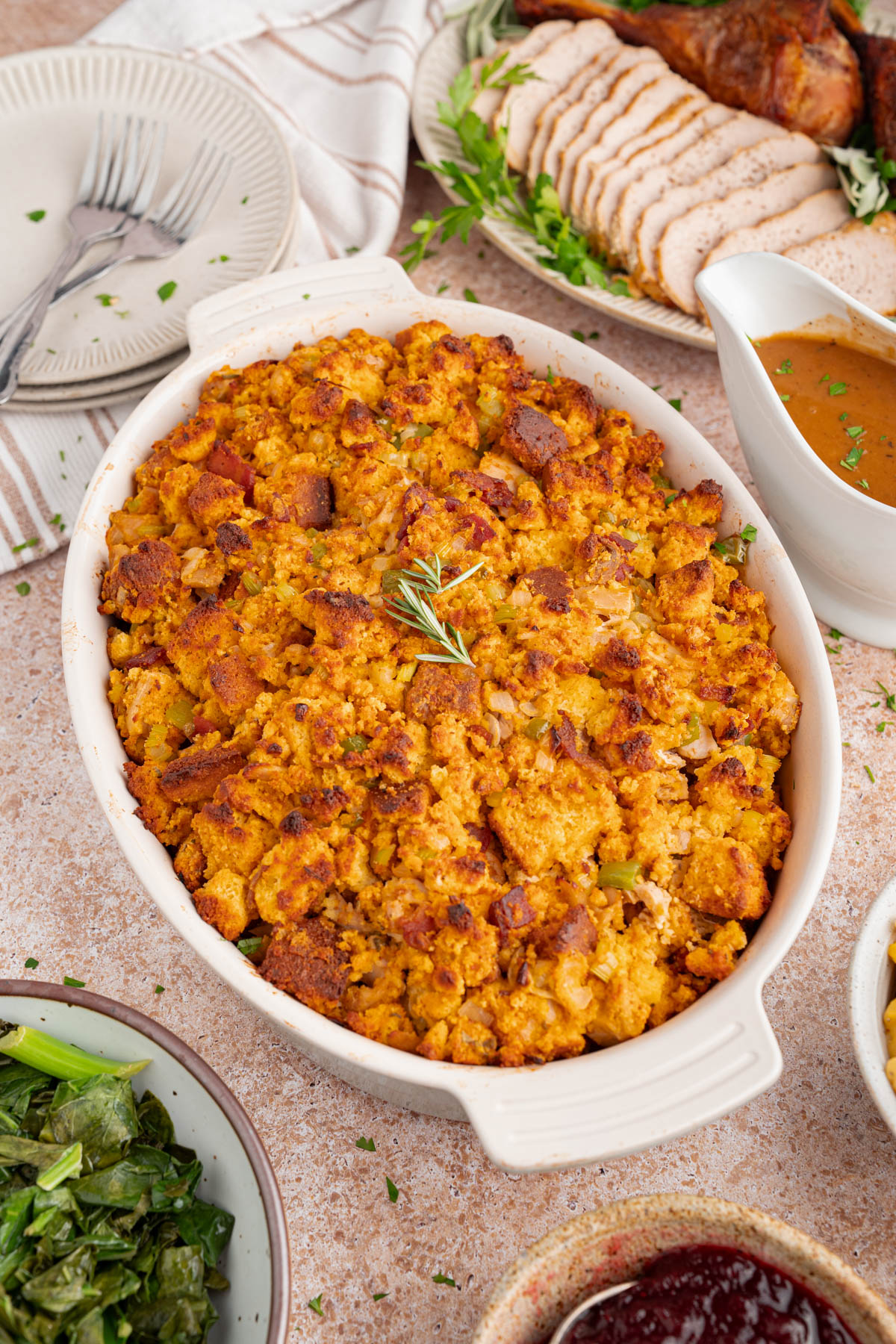 Baked cornbread dressing in a casserole dish on a countertop for serving.