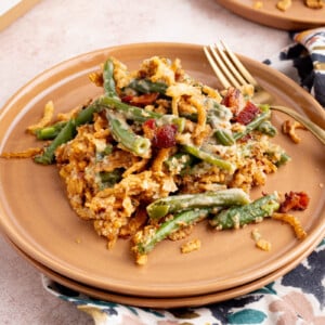 A scoop of green bean casserole on a plate for serving.