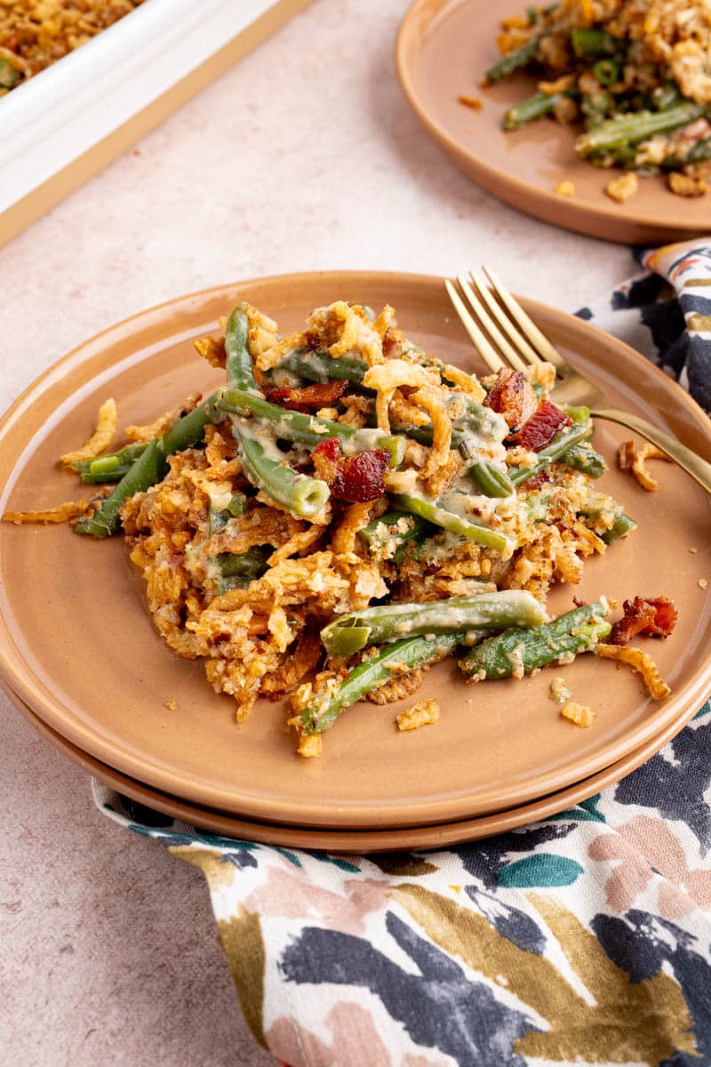 A scoop of green bean casserole on a plate for serving.
