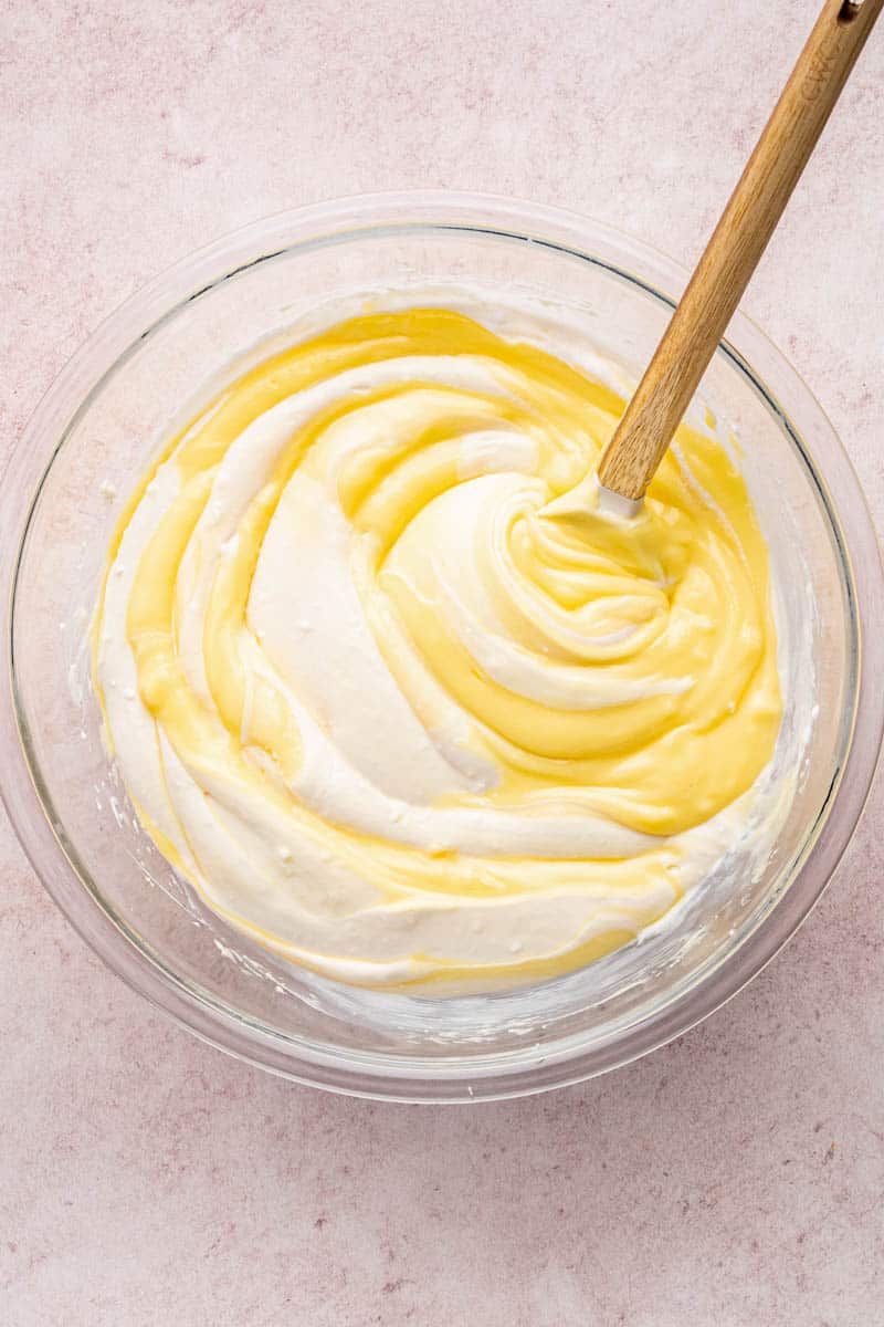 folding the whipped topping into the pudding mixture with a wooden spoon.