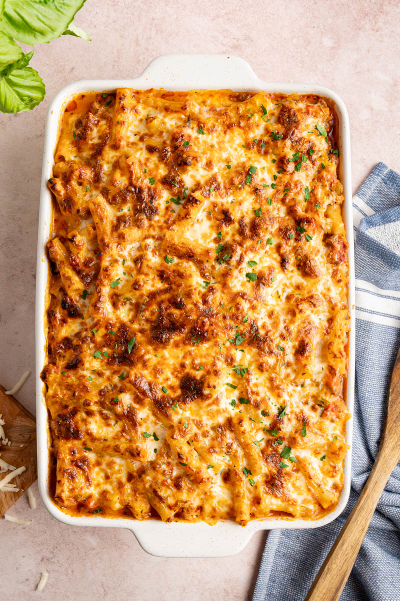 Baked ziti in a white baking dish right after coming out of the oven.