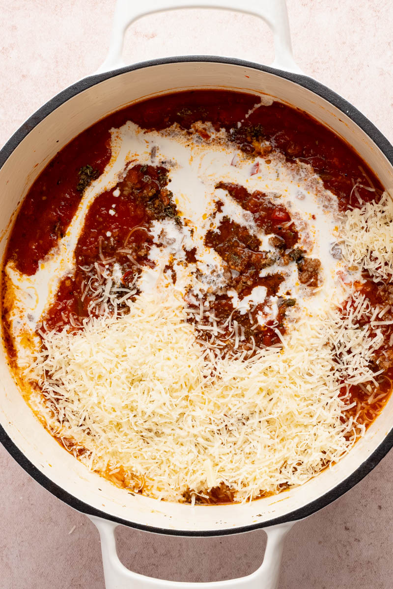 Add the cheese to the sauce before stirring and mixing with the pasta noodles.