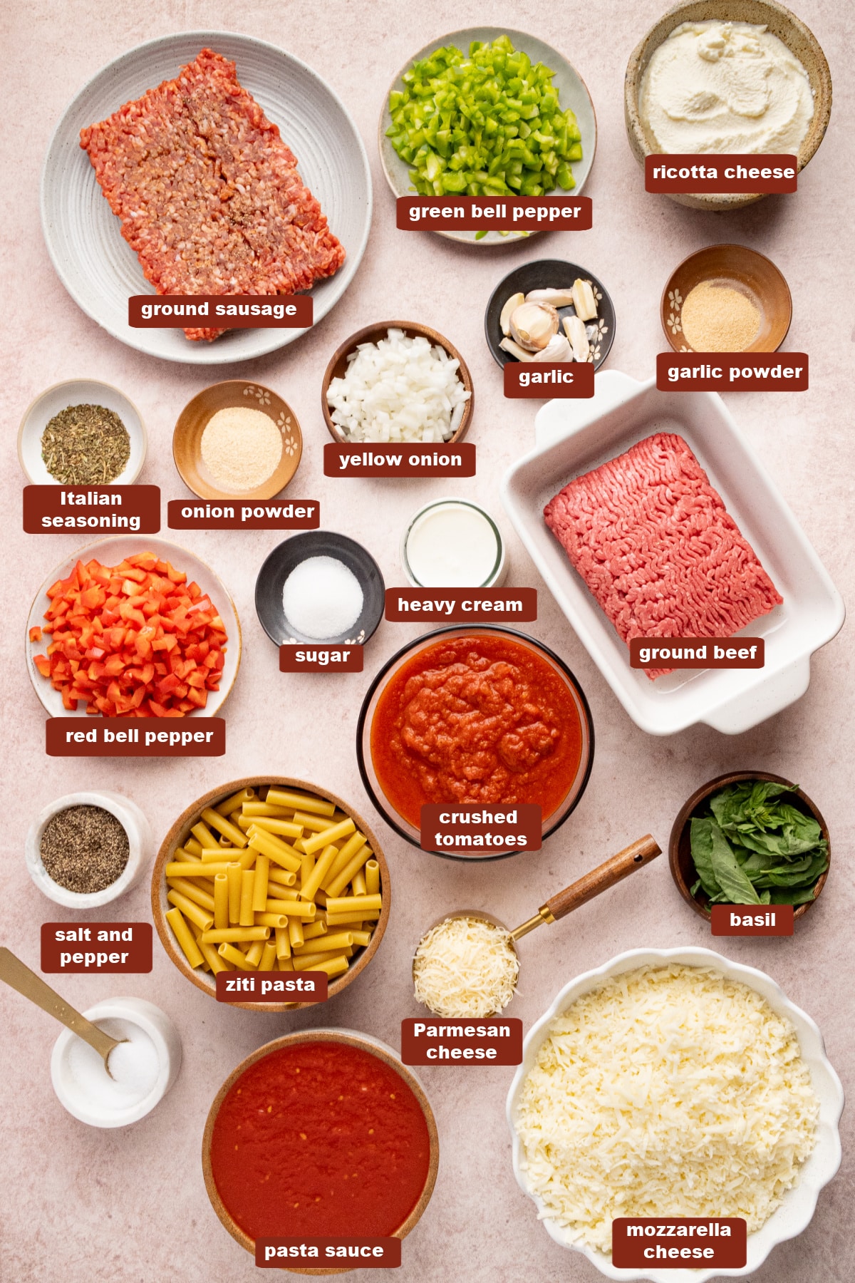 All of the ingredients baked ziti in bowls on a countertop.