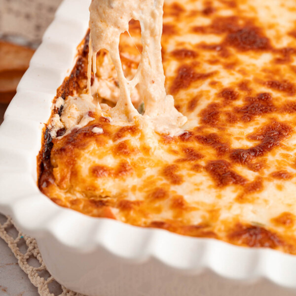 A baking dish filled with crab rangoon dip.