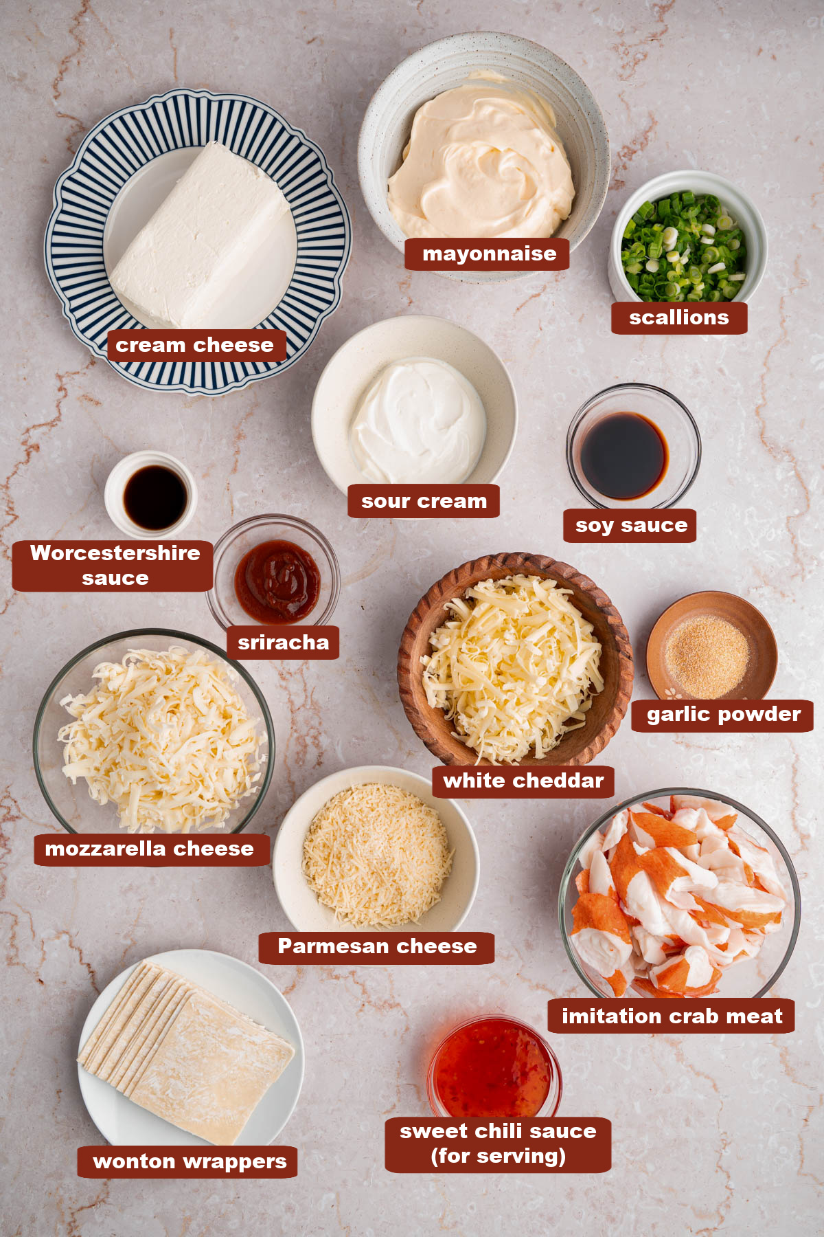 All of the ingredients for crab rangoon in bowls on a countertop.