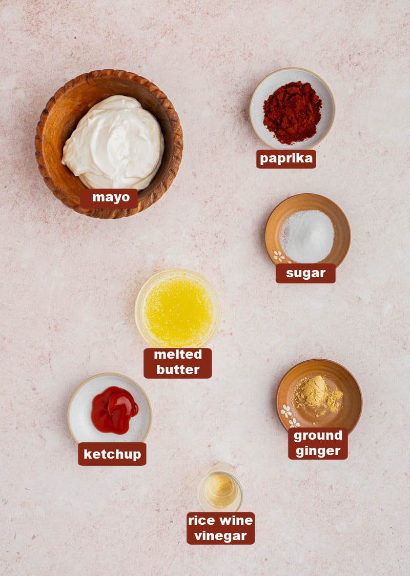 All of the ingredients for yum yum sauce in bowls on a countertop.