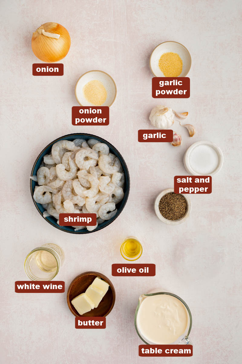 All of the ingredients for camarones al ajillo in bowls on a countertop
