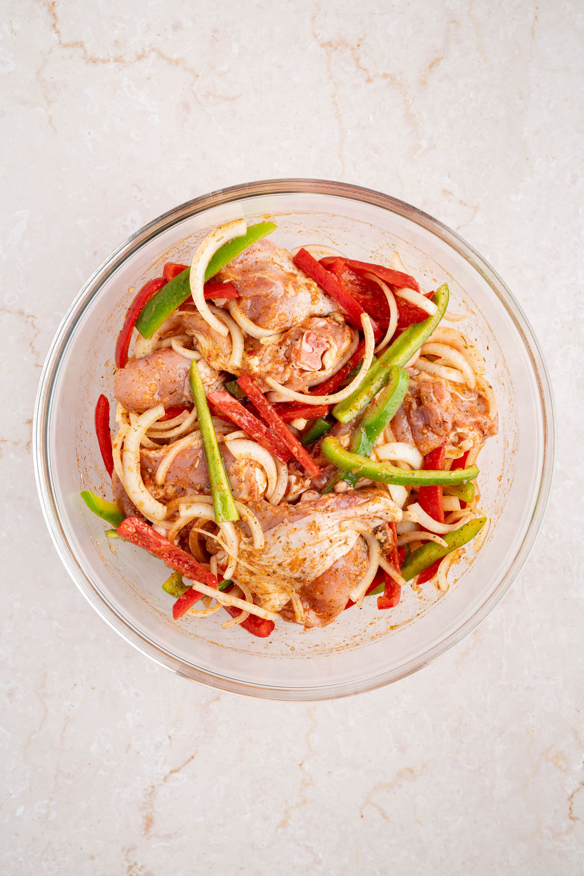 The italian dressing chicken marinating in a large bowl.