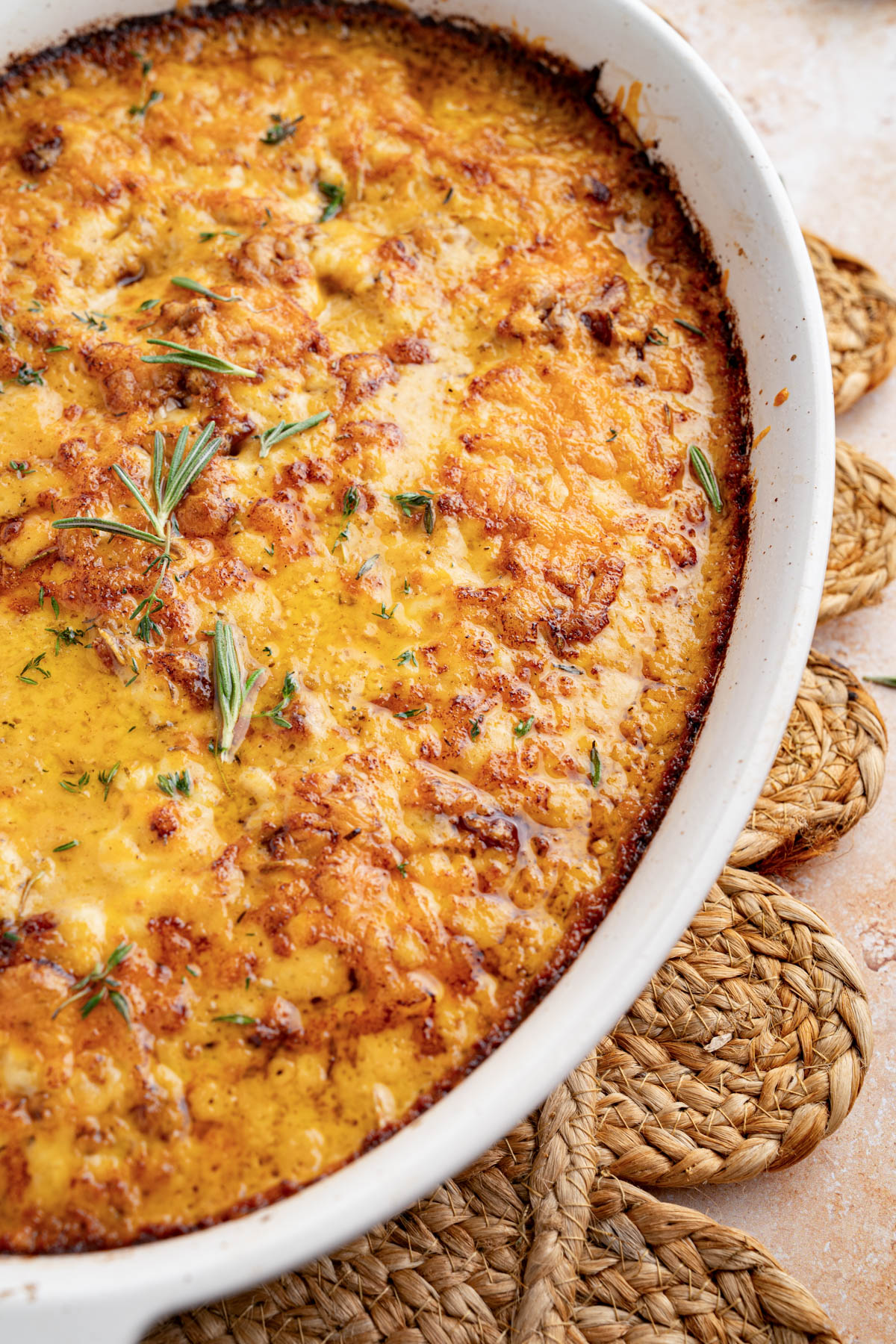 The baked au gratin potatoes in a oval baking dish on the counter.