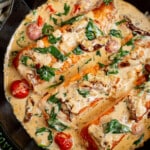 Creamy Tuscan Salmon in a cast iron skillet for serving.
