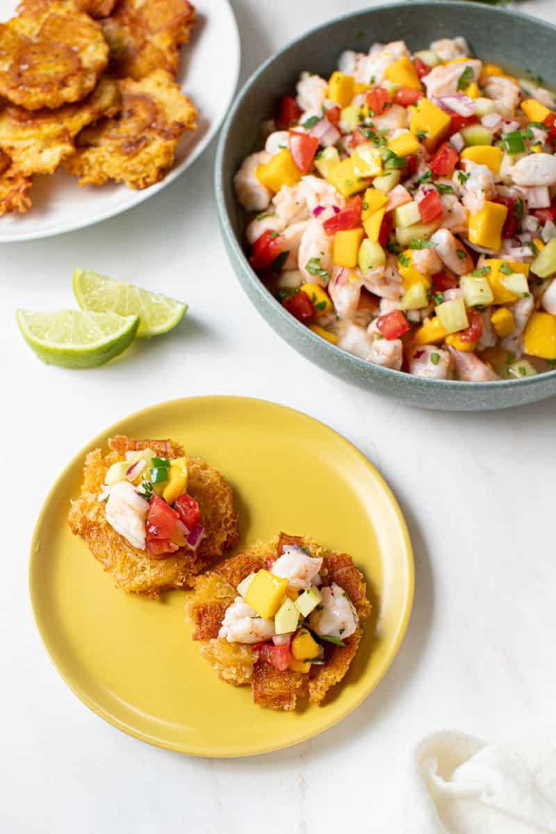 Fresh mango ceviche piled on top of fried tostones for serving.