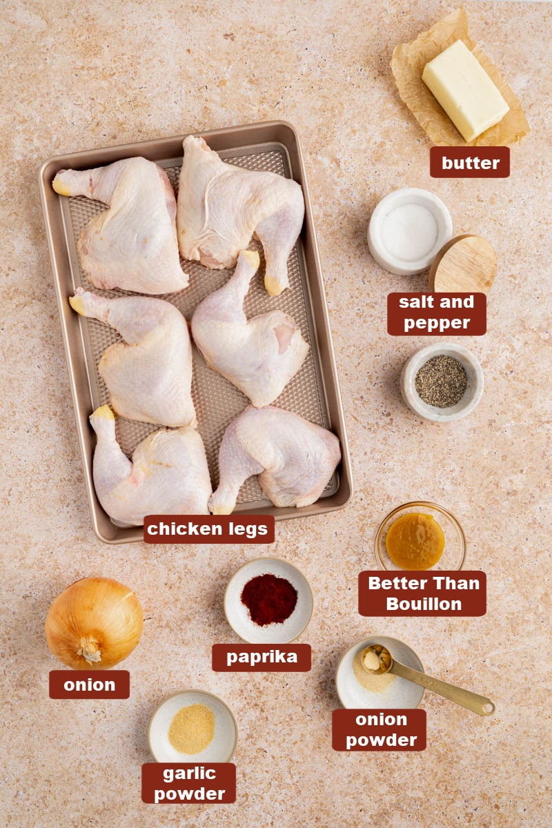 All of the ingredients for roasted chicken leg quarters in bowls on a countertop.
