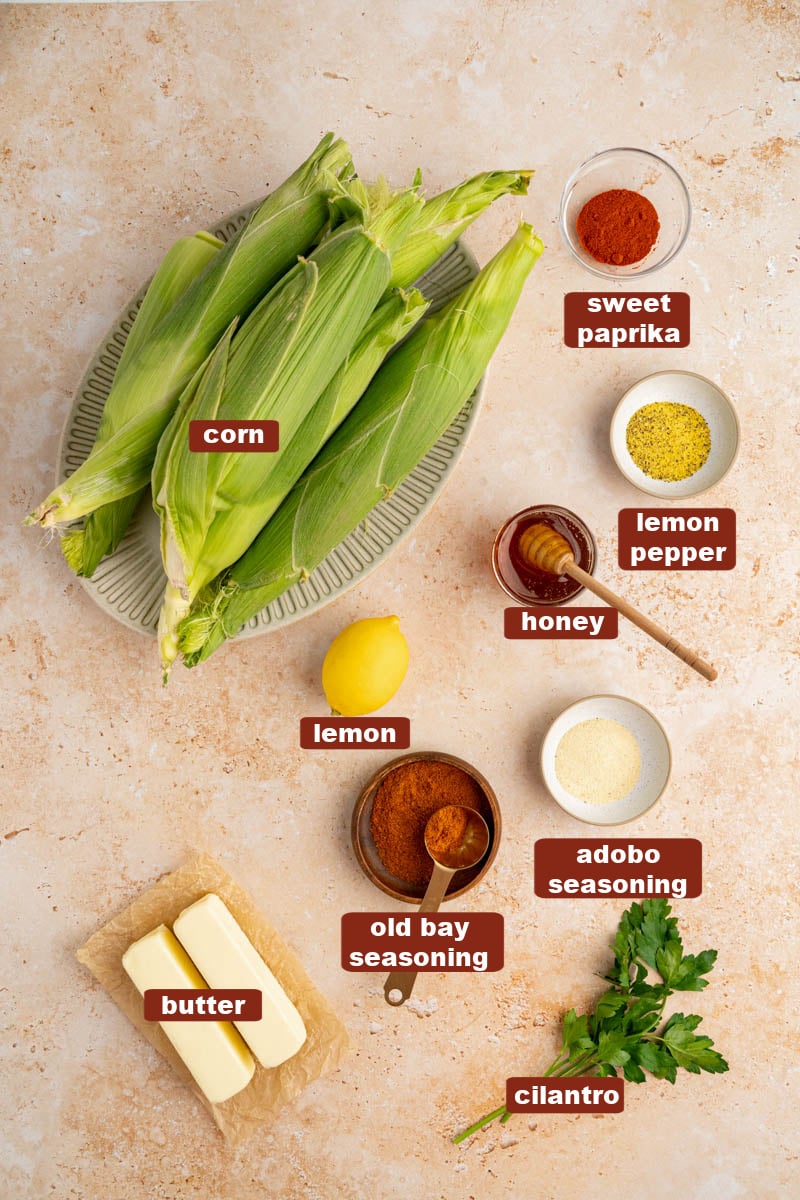All of the ingredients for cajun butter corn on a countertop.