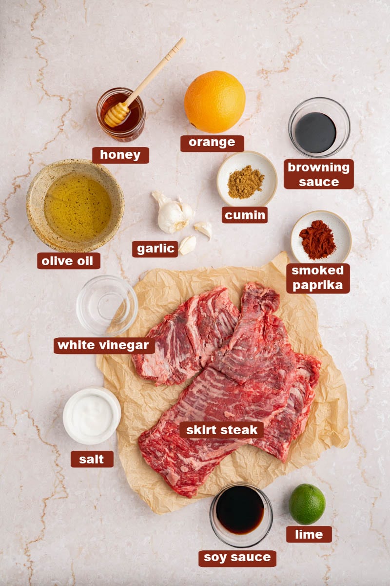 All of the ingredients for skirt steak in bowls on a countertop. 