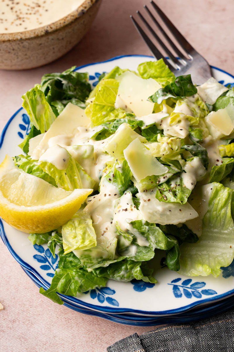 Classic caesar salad on a plate for serving.