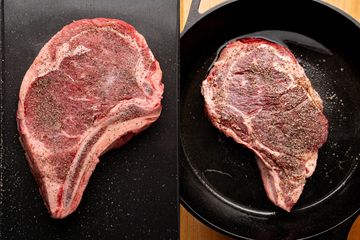 A ribeye steak in a skillet with hot oil and seasoned with salt and pepper.
