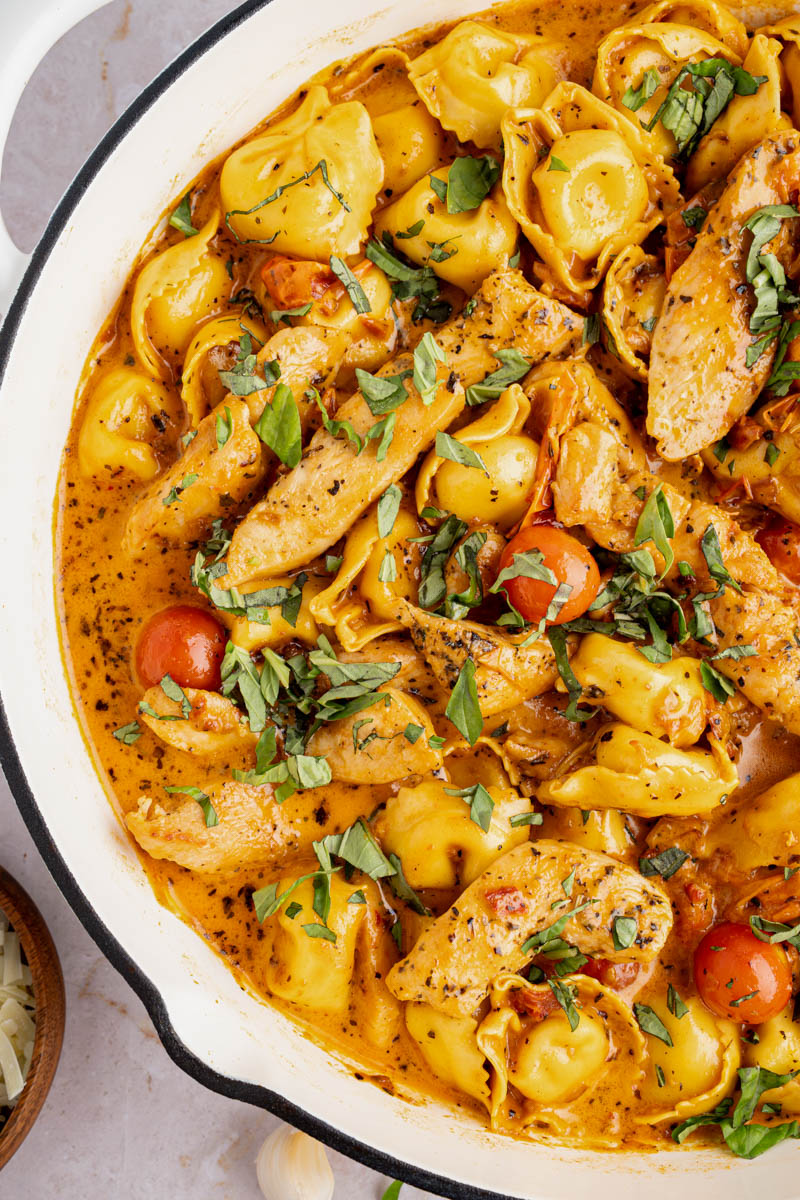 Creamy chicken tortellini in a skillet after cooking.