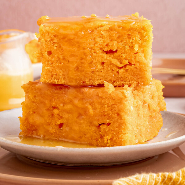 Two pieces of sweet potato cornbread stacked on a plate.