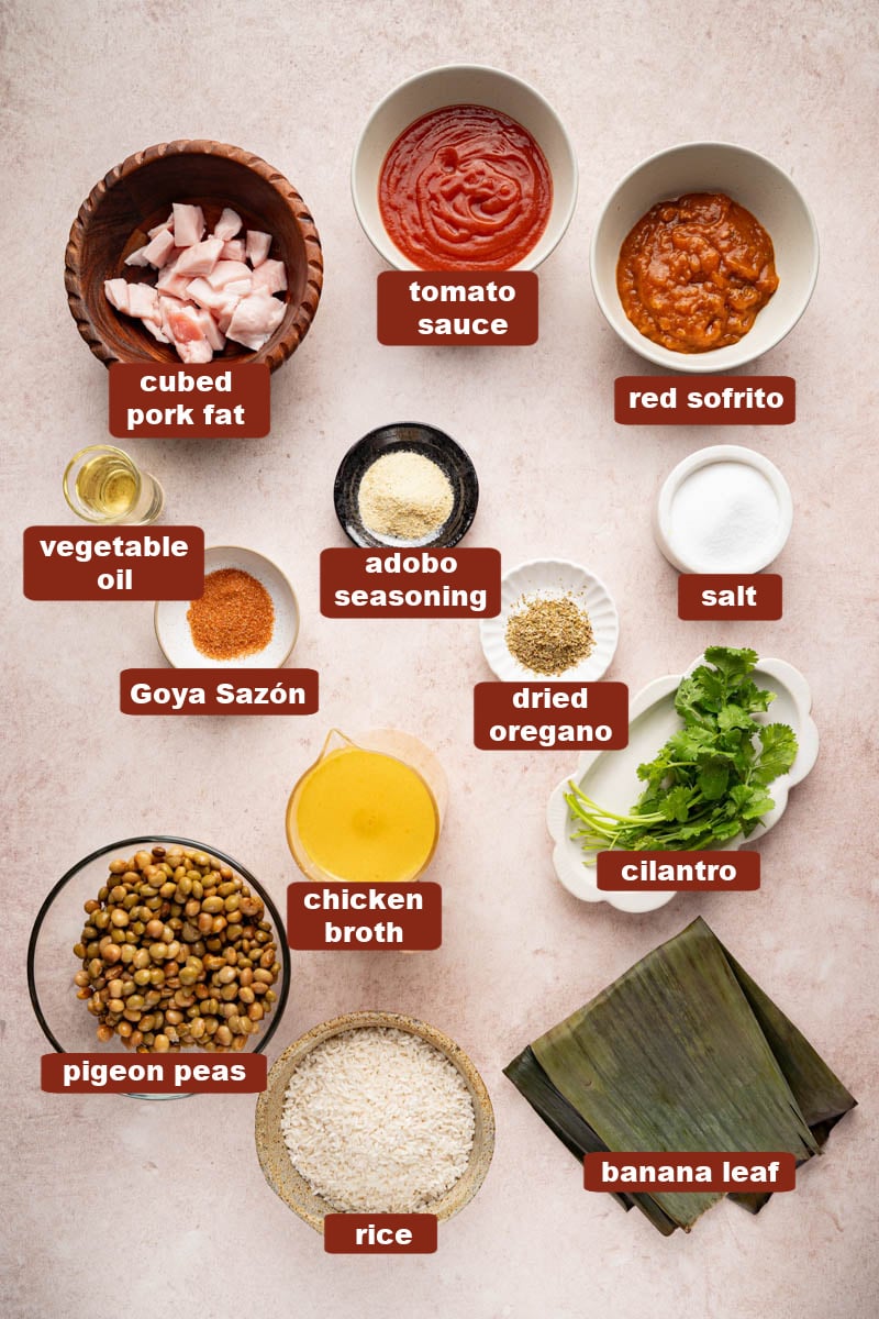 All of the ingredients for arroz con gandules in bowls on a countertop.