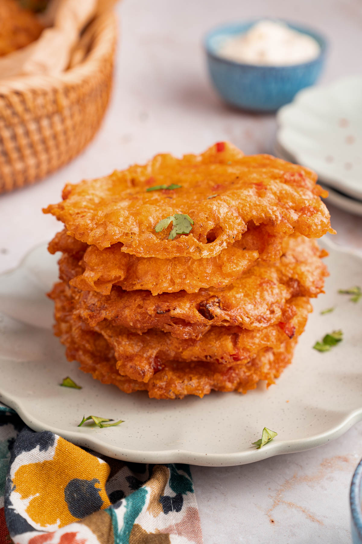 A stack of bacalaitos on a white plate for serving.
