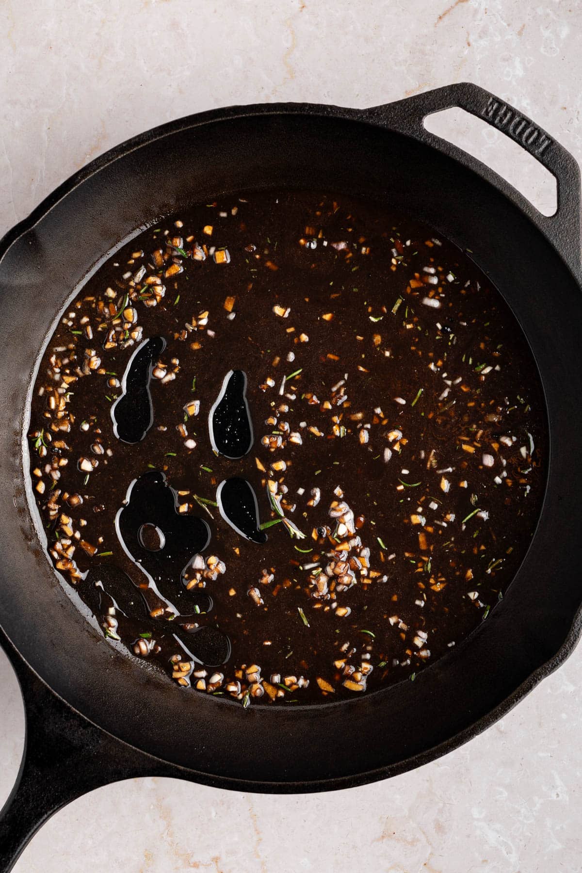 The glaze cooking down in the skillet.