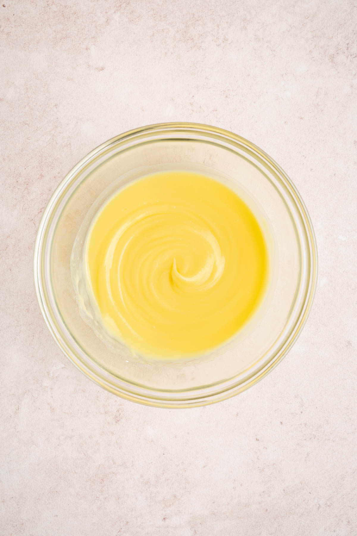 The pudding in a glass bowl on a countertop after mixing with cold milk and sitting for 5 minutes.