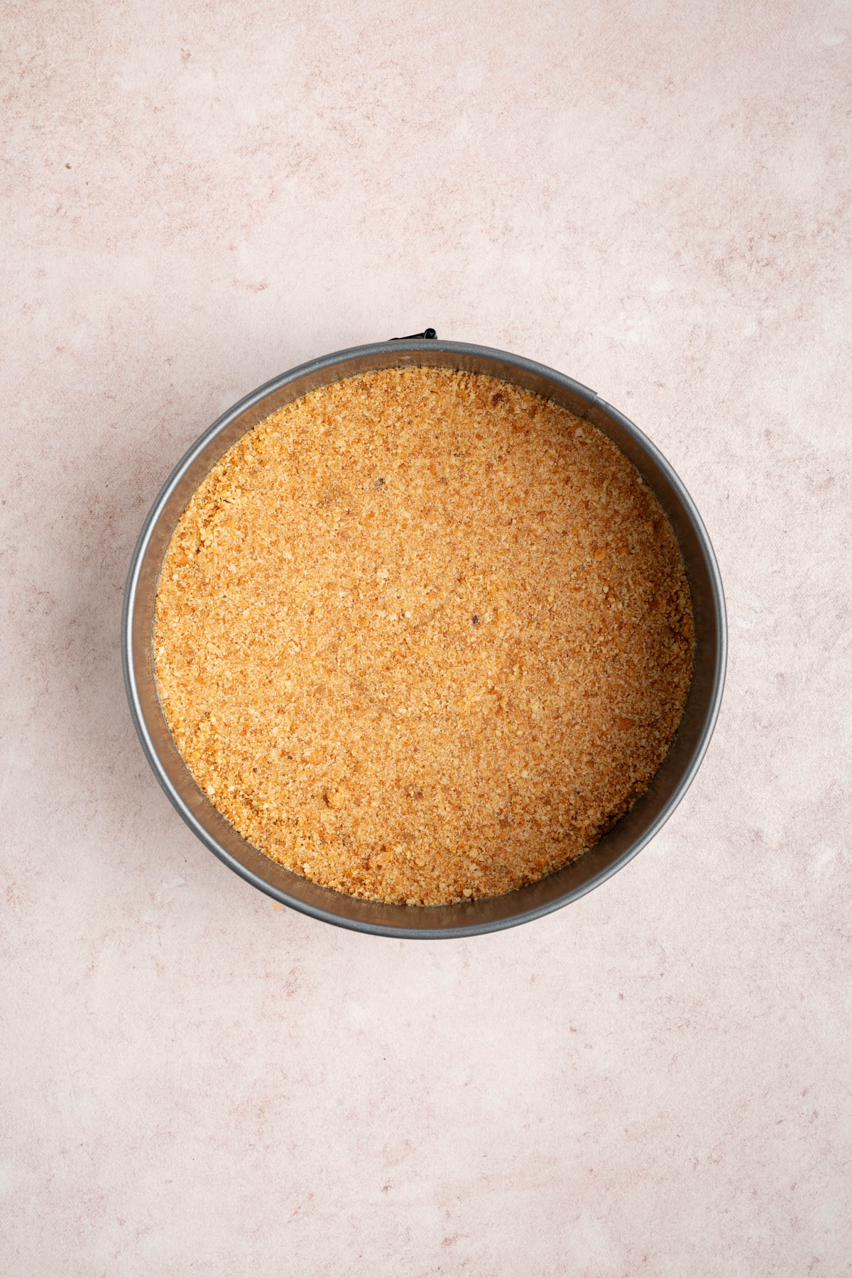 The crust mixed pressed into the bottom of a lined 9-inch springform pan.