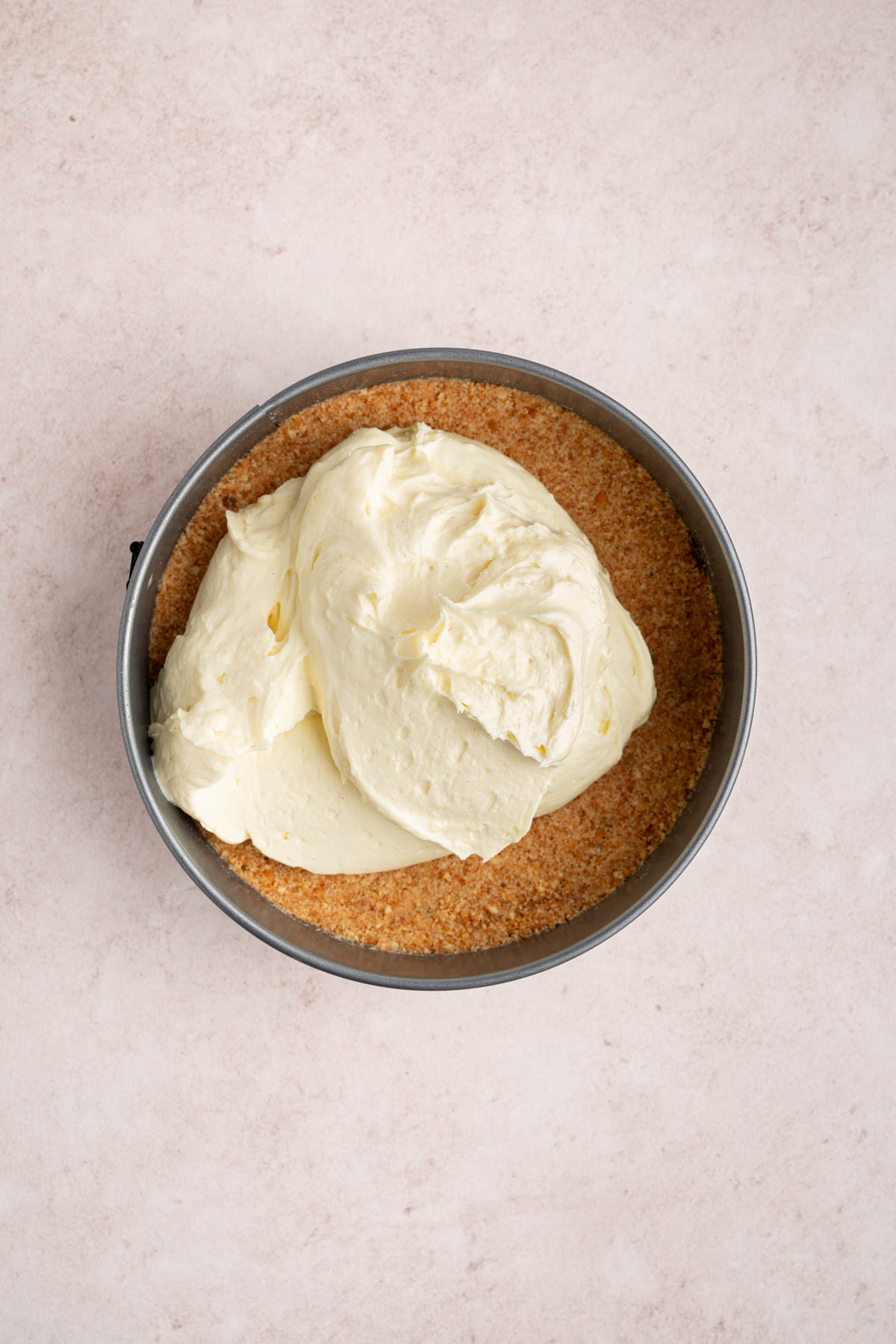 The cheesecake mixture in the pan on top of the chilled crust.