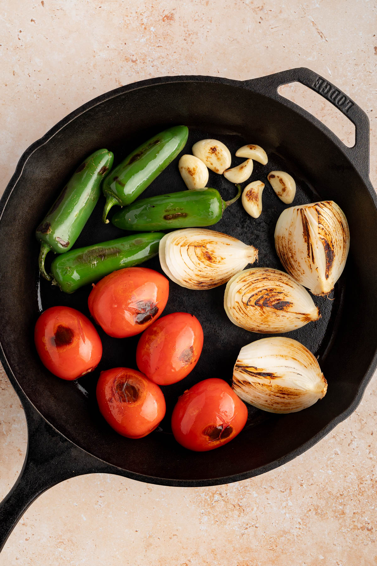 The charred vegetables in the cast iron skillet.