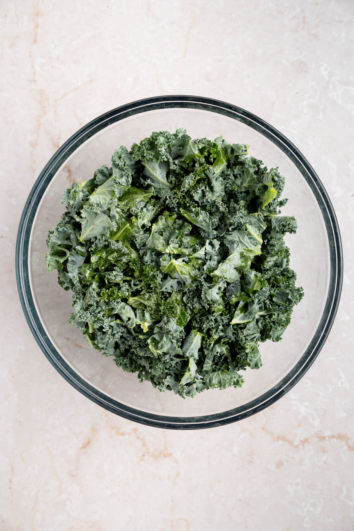 The kale in a large bowl before massaging.
