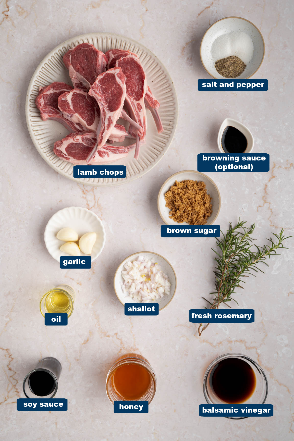 All of the ingredients for baked lamb chops in bowls on a white countertop.