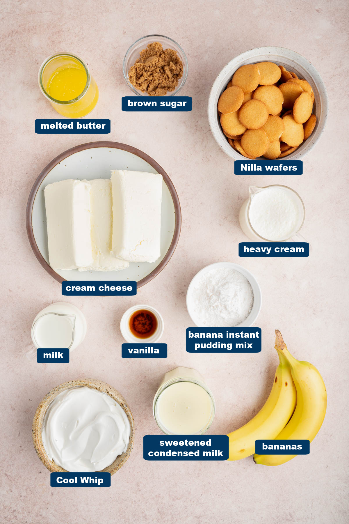 All of the ingredients for no bake banana pudding cheesecake in bowls on a countertop.