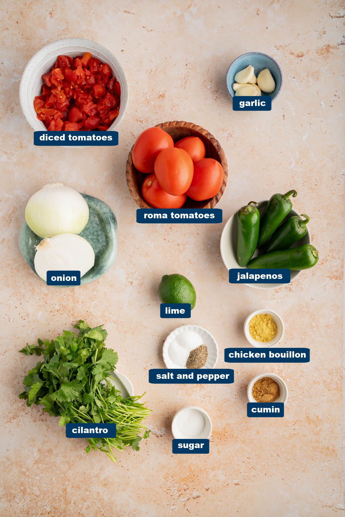 All of the ingredients for restaurant-style chunk salsa in bowls on a countertop.