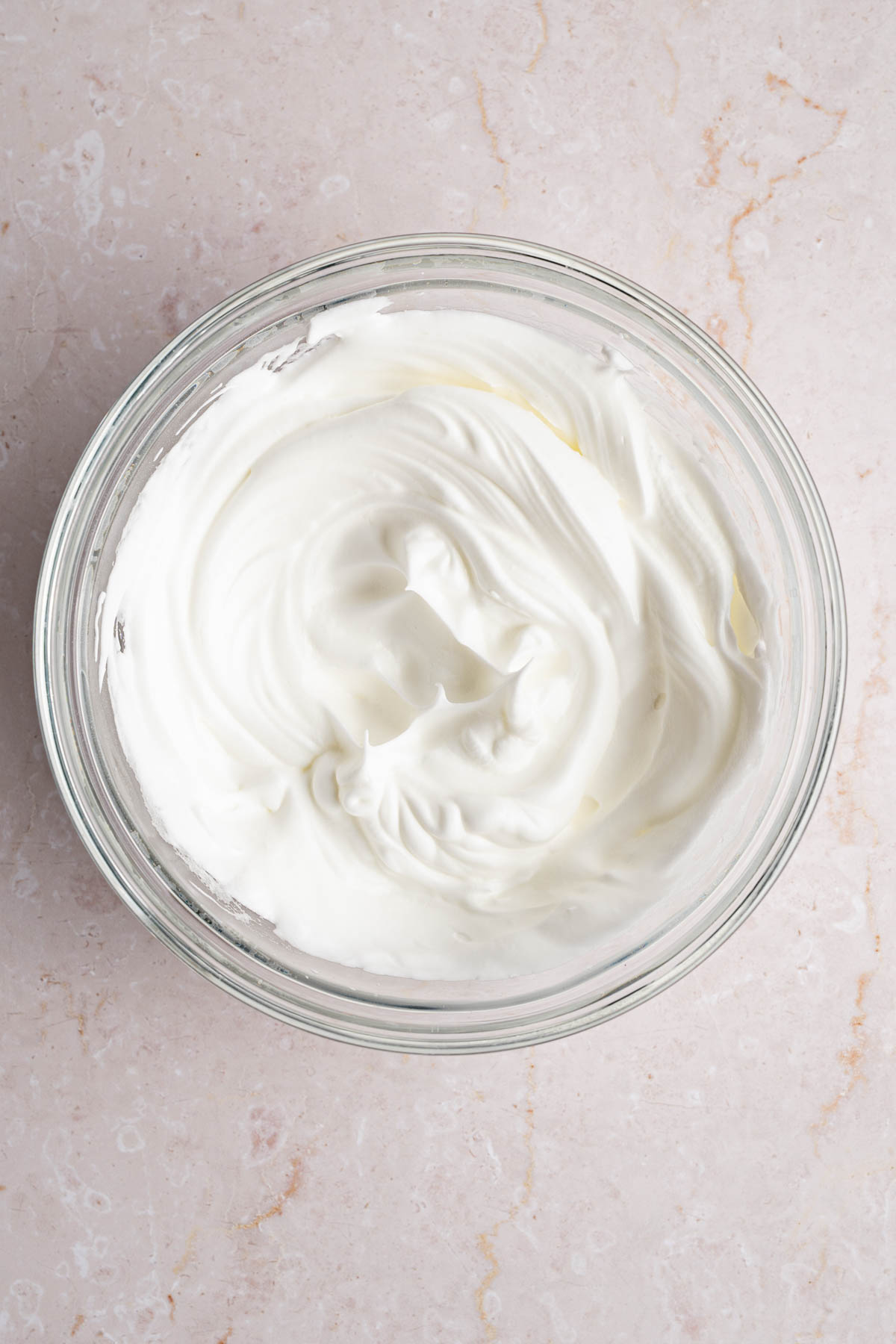 The beaten egg whites in a large bowl.