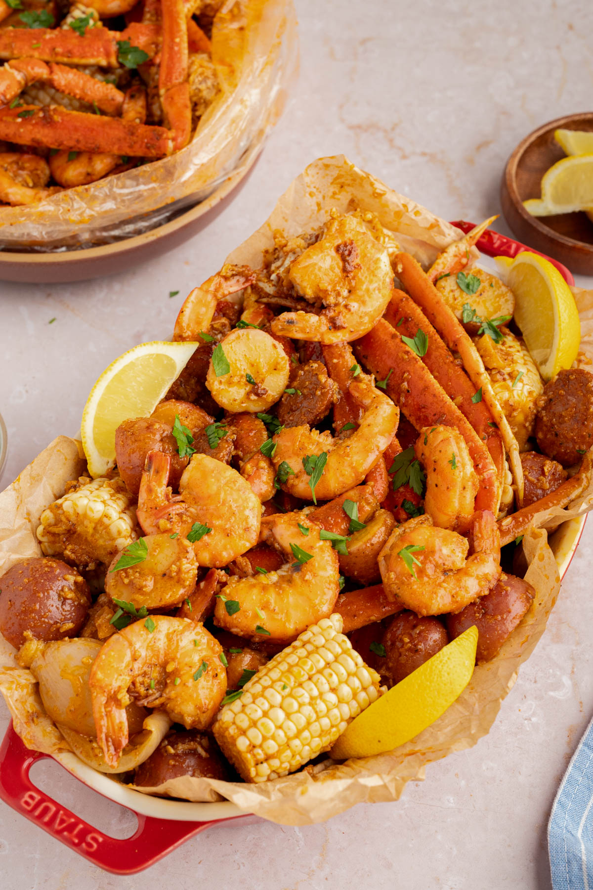 The seafood boil poured into a serving dish lined with paper.