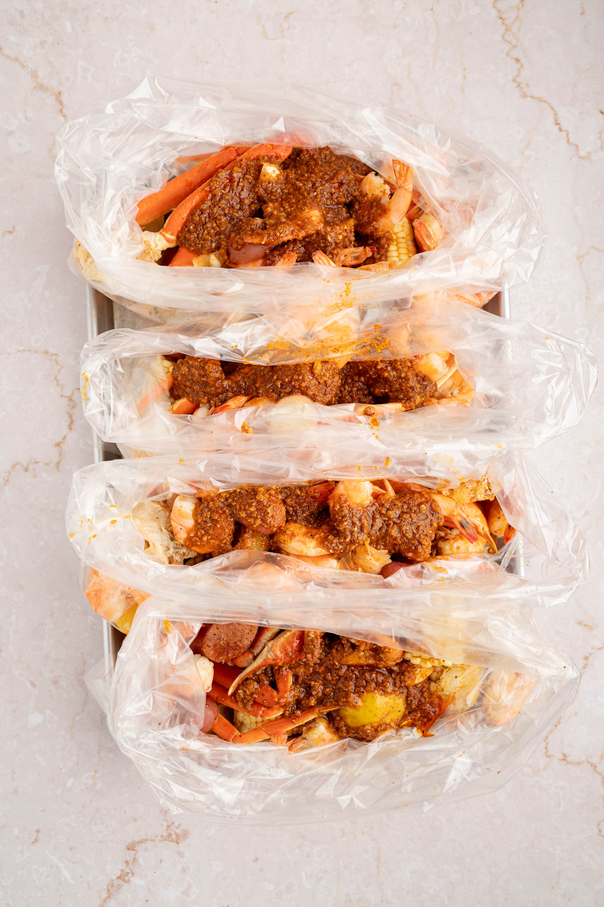 The seafood boil in the bags with the sauce poured over it before mixing everything together.