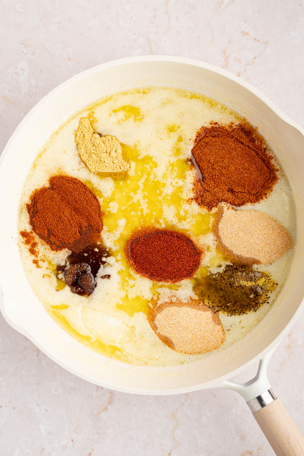 The seasonings for the sauce in the pan before stirring together.
