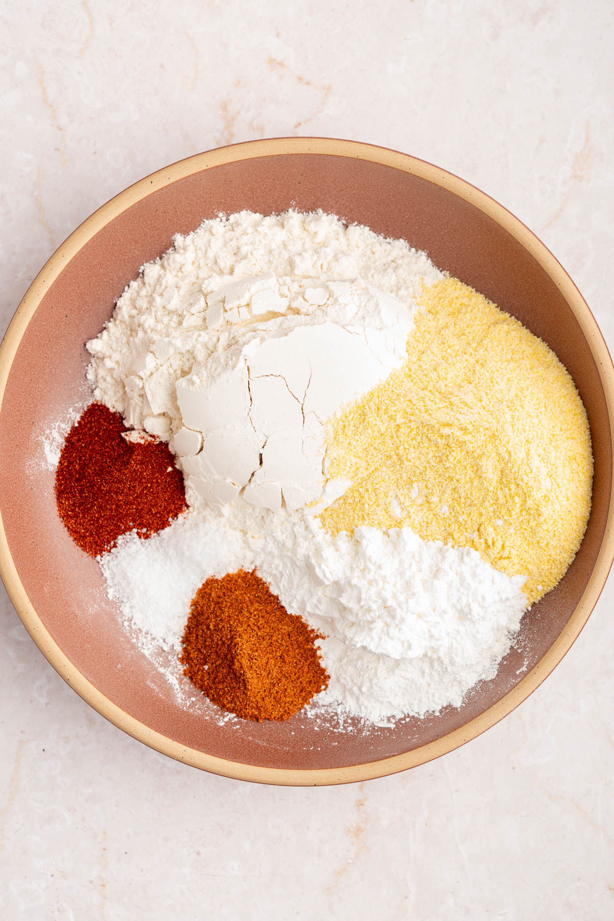 The ingredients for the dredge in a large bowl before whisking together.