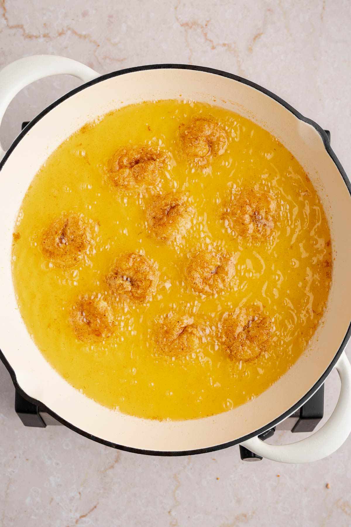 The shrimp frying in the preheated oil.