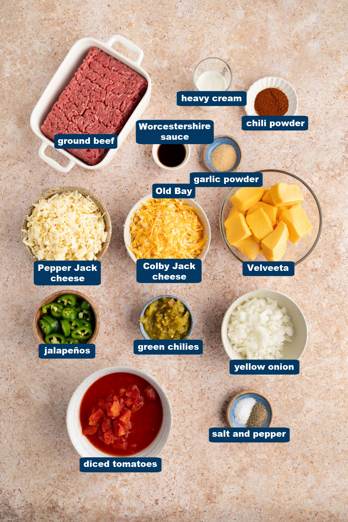 All of the ingredients for rotel dip in bowls on a countertop.