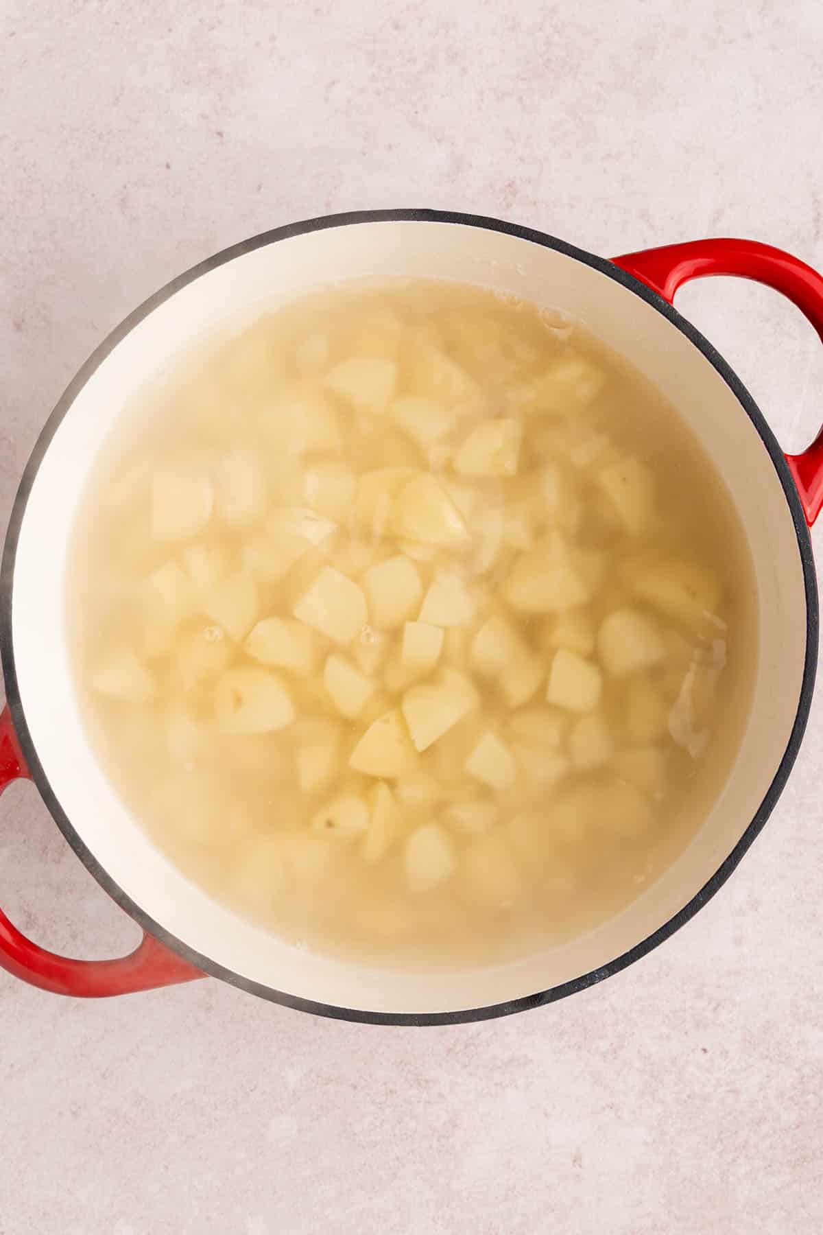 The potatoes boiling in water.