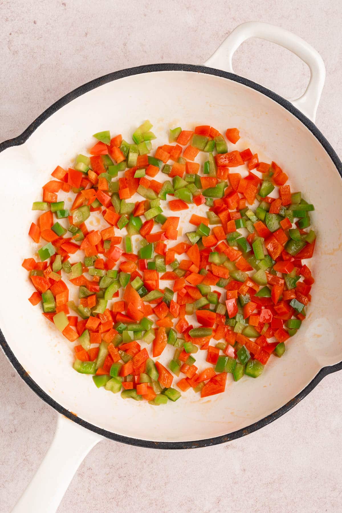 The peppers in the skillet while cooking.