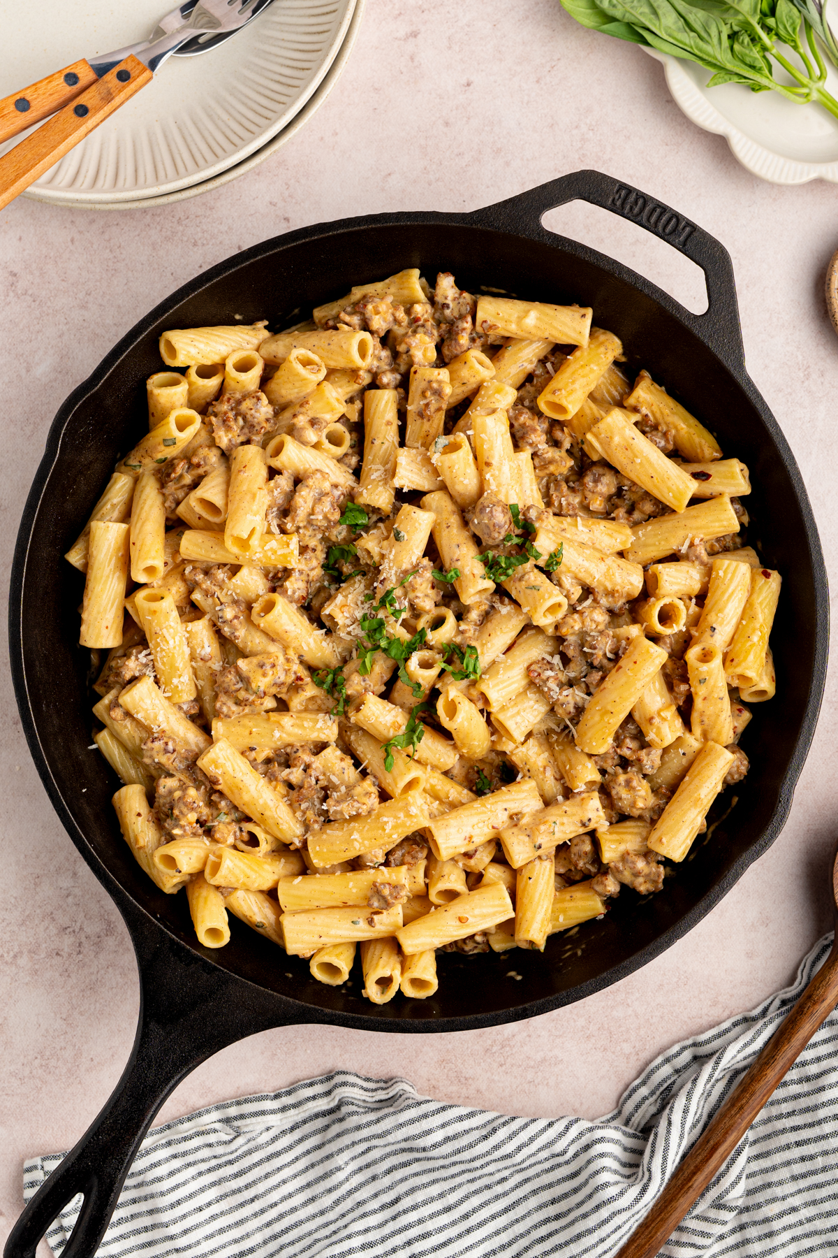 The creamy italian sausage rigatoni in the skillet on a countertop for serving.
