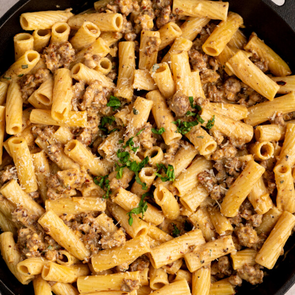 Creamy sausage rigatoni in a cast iron skillet after cooking.