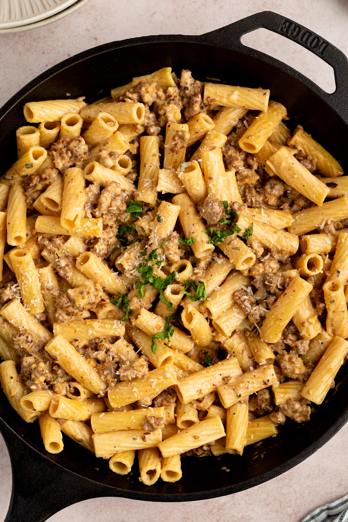 Creamy sausage rigatoni in a cast iron skillet after cooking.
